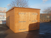 Pent style garage with large double doors viewed from the front. 