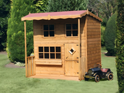 Wooden playouse with 2 levels, red roof, 3 front windows, stable single door, viewed from the the front/right side. 
