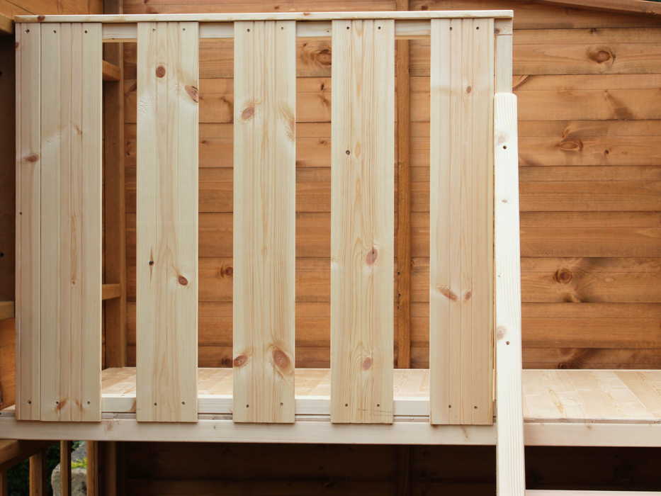 Close up of safety barrier on the interior of wooden playhouse. 