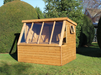 Wooden shed with long slanted windows, side opening window staging under windows, viewed from front/right side. 