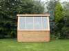 Wooden shed with long slanted windows. Viewed from the front. 