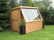 Wooden potting shed with long slanted windows, stable side door. Viewed from thre front/left side. 