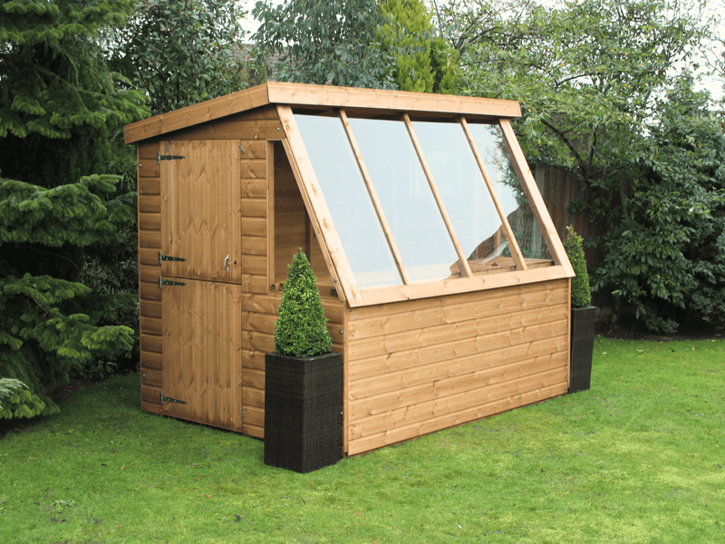 Wooden potting shed with long slanted windows, stable side door. Viewed from thre front/left side. 