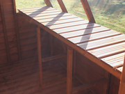 Interior of wooden potting shed, close up of slatted staging. 