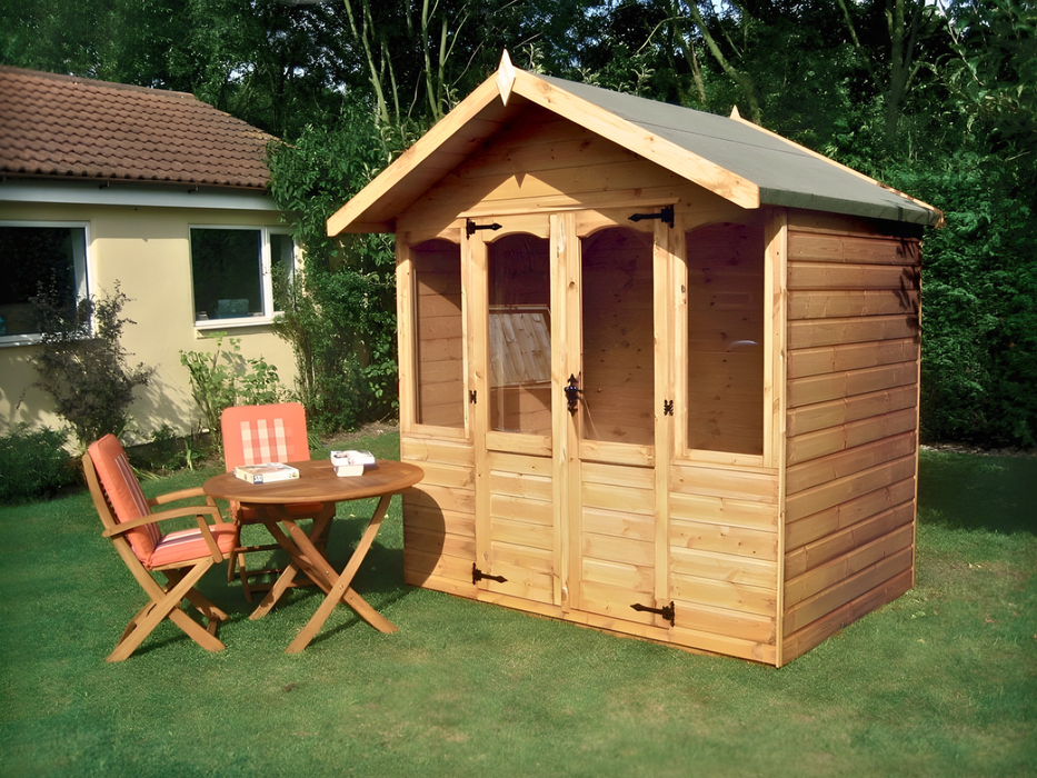 Wooden summerhouse with double doors and two windows on either side of door. Viewed from the front/right side. 
