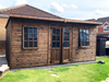The Studio Summerhouse with open double doors and two opening side windows, viewed from the front