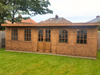 The Studio Summerhouse with double doors and four opening side windows, viewed from the front