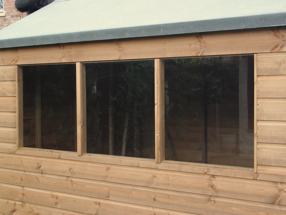Close up of three side windows on classic wooden shed. 