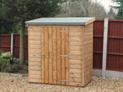Small wooden tool shed with single door, viewed from the front. 