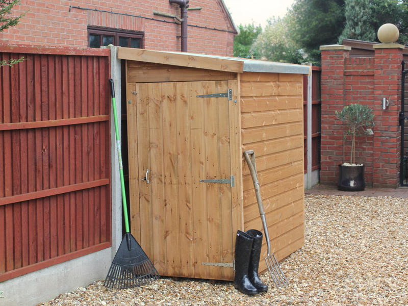 Small wooden tool shed with closed single door, viewed from the left side.