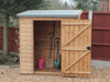 Small wooden tool shed, single door open showing interior, viewed from the front. 