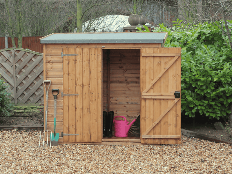 Small wooden tool shed with one door open, one shut, viewed from the front. 