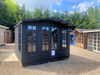 The Windsor Summerhouse painted in black with double doors and four opening side windows, viewed from the front