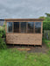 Lunar potting shed front view in a garden