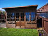 The Studio summerhouse in a garden