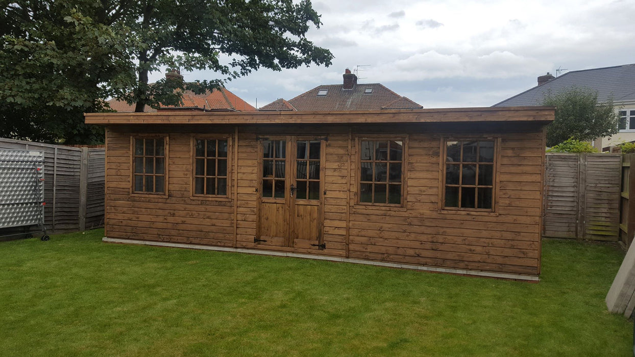 An extra large studio summerhouse at the end of a garden